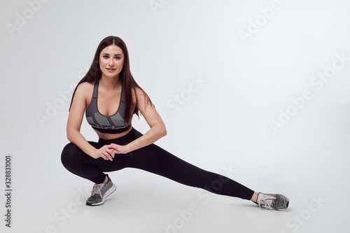  woman in sportswear doing exercises isolated