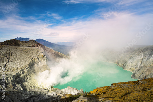 View from above, stunning view of the Ijen volcano with the turquoise-coloured acidic crater lake. The Ijen volcano complex is a group of composite volcanoes located in East Java, Indonesia.