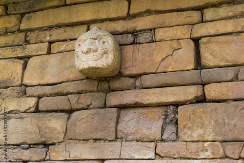 A Nail head (Cabeza Clava) or zoomorphic face carved in stone  from the pre-incan culture Chavin in Ancash Region, Peru photo