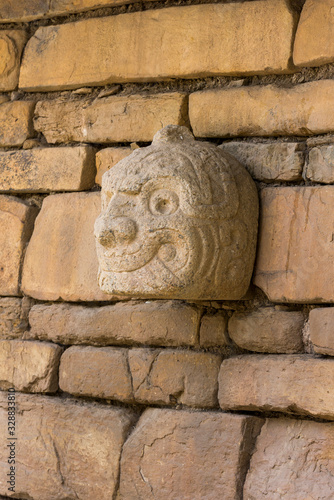 A Nail head (Cabeza Clava) or zoomorphic face carved in stone  from the pre-incan culture Chavin in Ancash Region, Peru photo