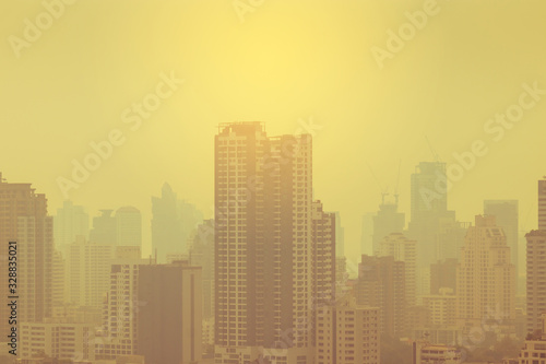 smog city in summer with morning sunlight  haze of pollution covers city  global warming concept