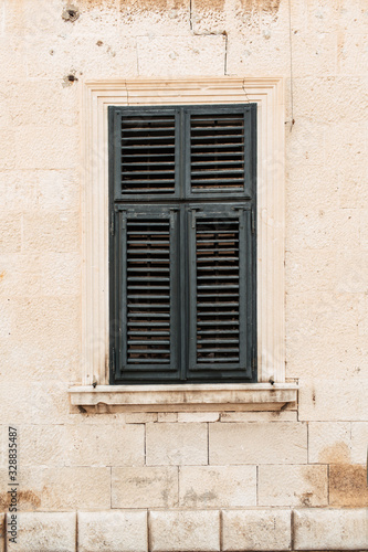 Minimal travel concept. Green wood shutters on old building. Front view. Old town and architecture in Europe,, Croatia, Dubrovnik.