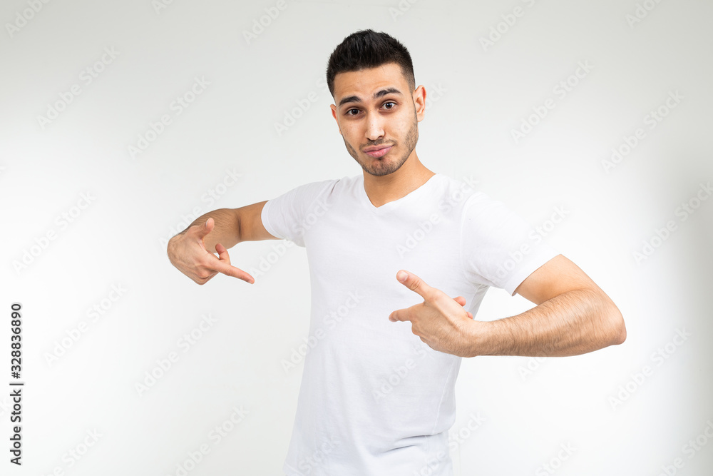 man in a white T-shirt with a template for printing on a white studio background man in a white T-shirt with a template for printing on a white studio background