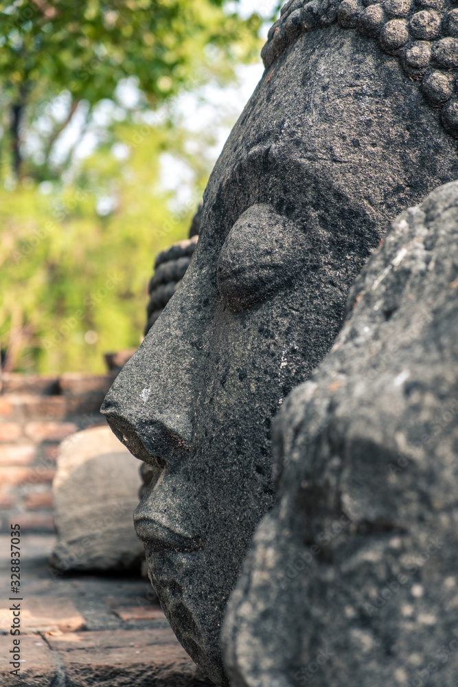 Head of Buddha in stone. Ruin of Ayutthaya
