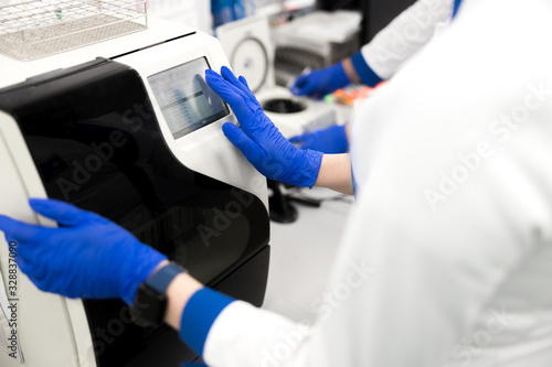 Scientist using advia immunoassay system in laboratory