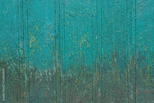 green gray wooden texture from old dirty boards in the fence wall on the street