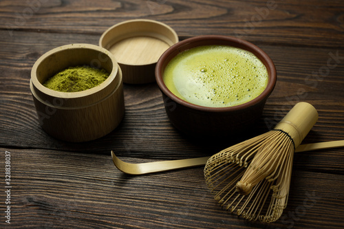 matcha tea with a cup stands on a wooden table