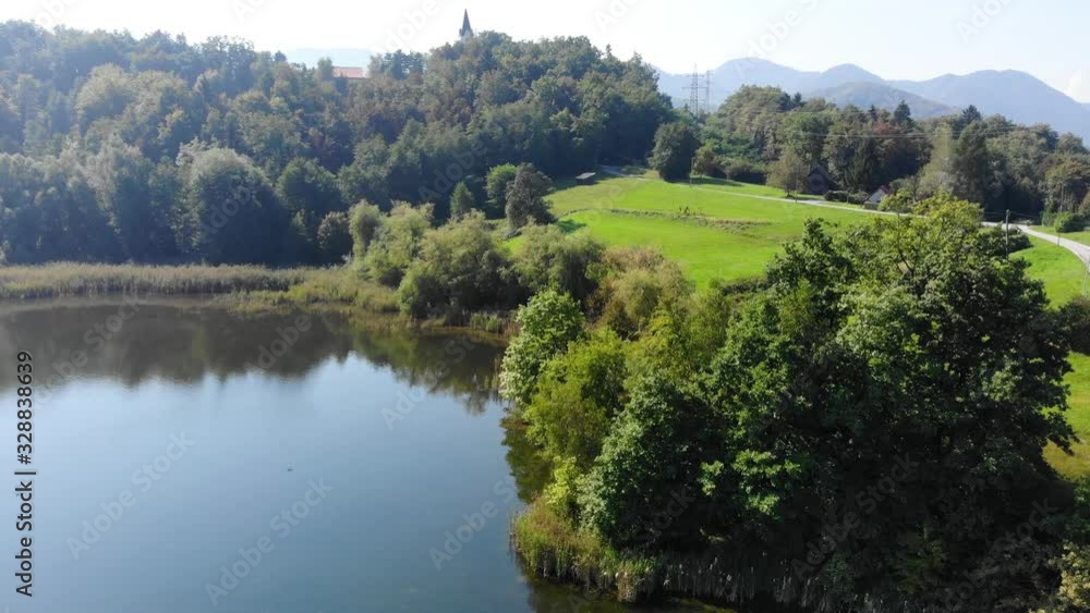 Power transmission lines on shore of a Lake used for chemical waste disposal, Aerial dolly in approach Power transmission lines on shore of a Lake used for chemical waste disposal, Aerial dolly in approach
