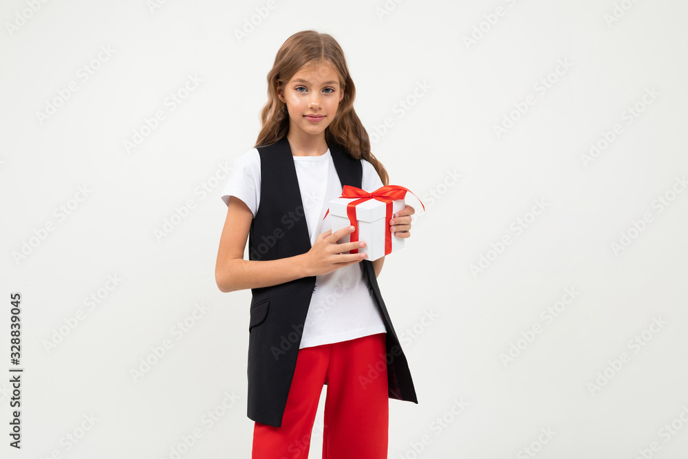 Pretty little girl in costume stands with gift isolated on white background Pretty little girl in costume stands with gift isolated on white background