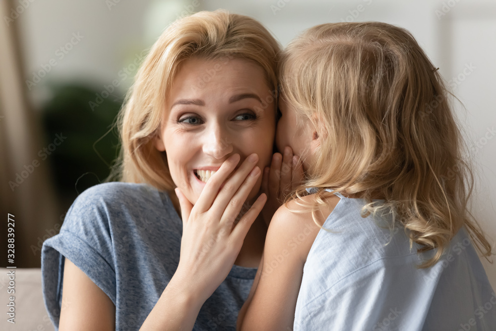 Cute little girl whisper in young mom ear share secret enjoy close tender moment together, small preschooler daughter chat gossip with smiling mother, share sweet intimate time, bonding concept Cute little girl whisper in young mom ear share secret enjoy close tender moment together, small preschooler daughter chat gossip with smiling mother, share sweet intimate time, bonding concept