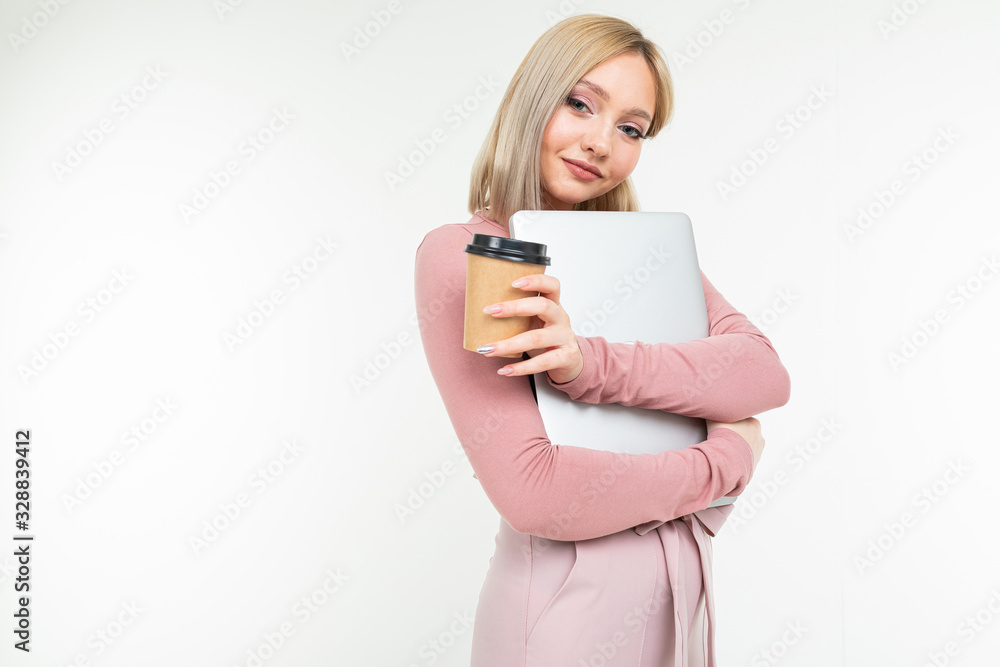 cute blond girl at break with a cup of coffee and a laptop in her hands on a white background cute blond girl at break with a cup of coffee and a laptop in her hands on a white background