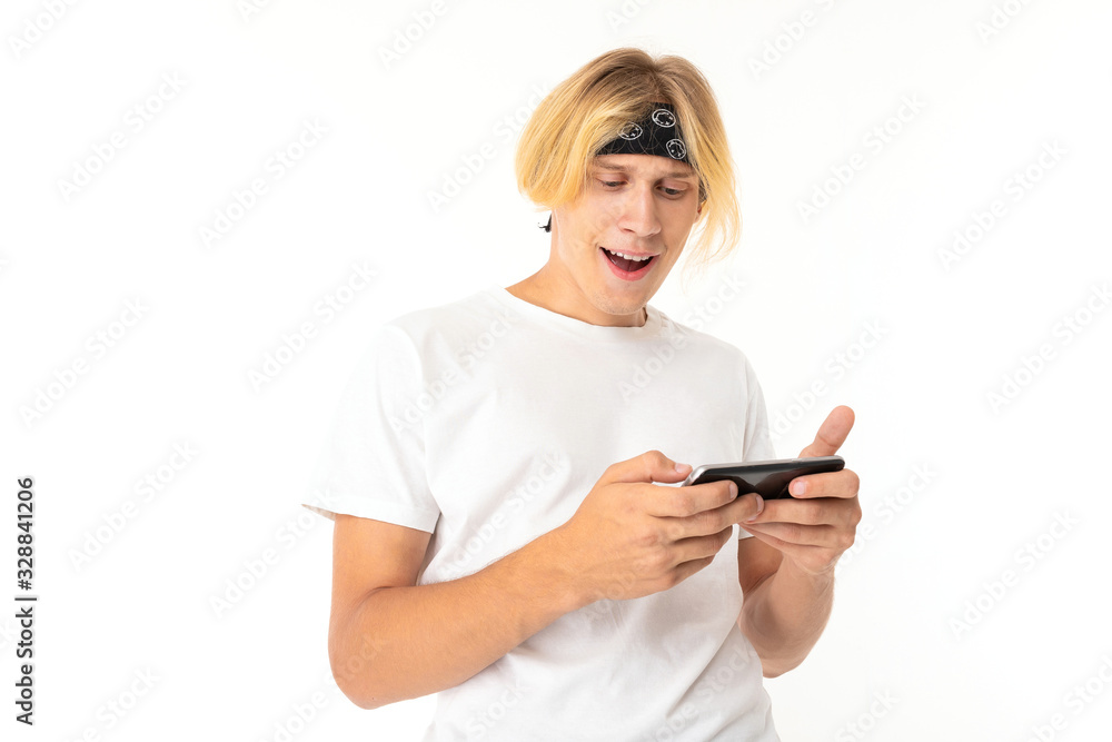 Beautiful young man with mobile phone isolated on white background Beautiful young man with mobile phone isolated on white background