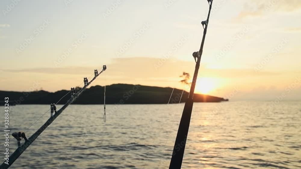 Deep sea fishing rod on a fishing boat at sunrise Deep sea fishing rod on a fishing boat at sunrise
