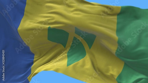 4k Saint Vincent and the Grenadines National flag slow loop seamless waving with visible wrinkles in wind blue sky background.A fully digital rendering-animation loops at 20 seconds. photo
