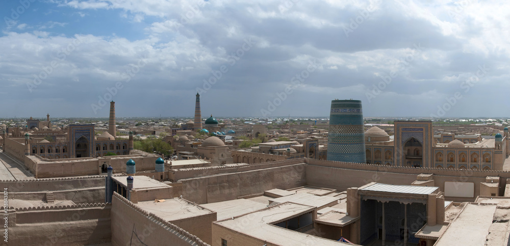 View at Itchan Kala (old or inner city), Kuhna Ark palace (fortress) and Kalta-minor Minaret. Khiva, Uzbekistan, Central Asia.