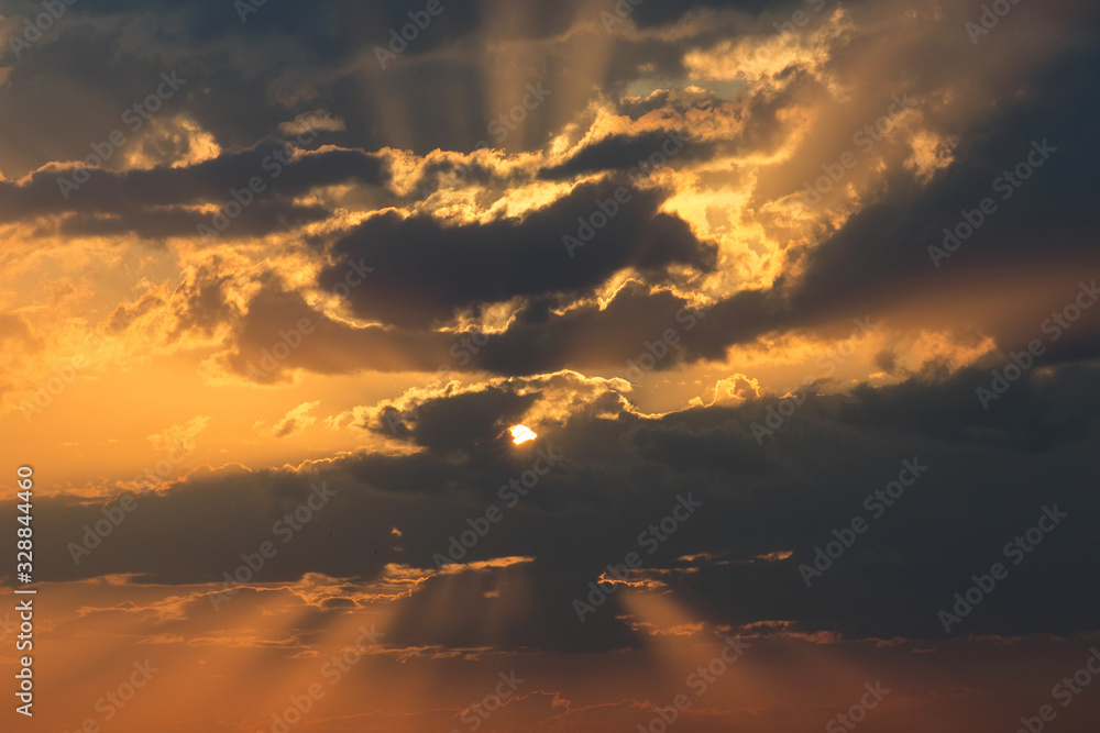 Beautiful sunset and sun beams going through the clouds. Khiva, Uzbekistan, Central Asia.