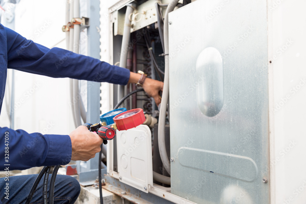 Technician is checking air conditioner ,measuring equipment for filling air conditioners. Technician is checking air conditioner ,measuring equipment for filling air conditioners.