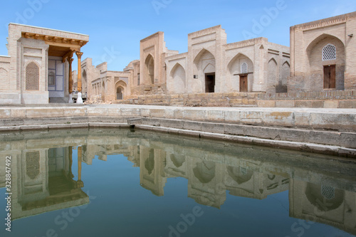 Memorial complex (cemetery) of Chor-Bakr. Tombs and reflection in the pond. Kalaya, outskirts of Bukhara, Uzbekistan, Central Asia.