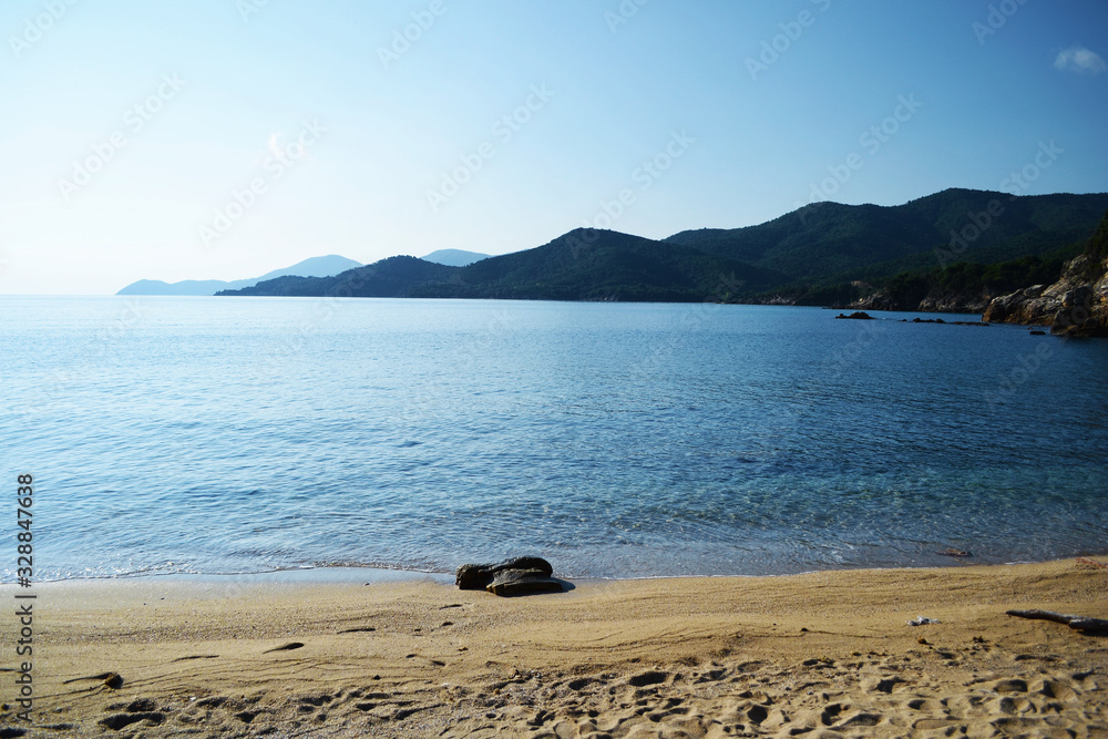 Landscape of amazing beach in Greece with blue sky clear watter and soft sand. Stagira beach.