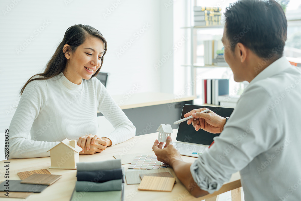 Young asian happiness couple love family male and female talking about house purchase discussing a choice with home plan, real estate and family house concept.house design ideas concept. Young asian happiness couple love family male and female talking about house purchase discussing a choice with home plan, real estate and family house concept.house design ideas concept.