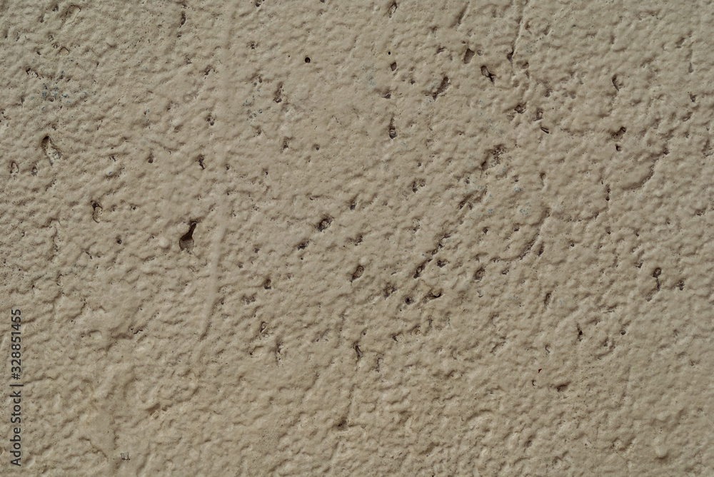 Stone surface beige colored with mottled texture. painted wall texture with unpainted recesses Stone surface beige colored with mottled texture. painted wall texture with unpainted recesses