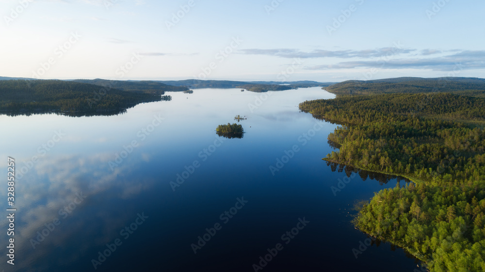 Aerial panoramic landscape view of a beautiful huge Lake Inarijarvi in Lapland at sunset.