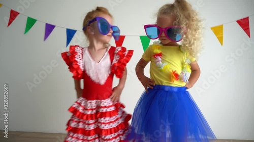 Two joyful funny children having fun and dancing at the party. Best friends girl