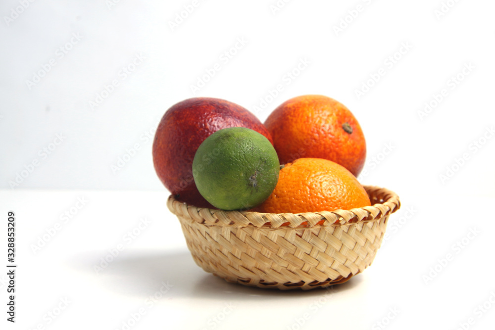 citrus fruits in a shopping basket isolated on white background citrus fruits in a shopping basket isolated on white background