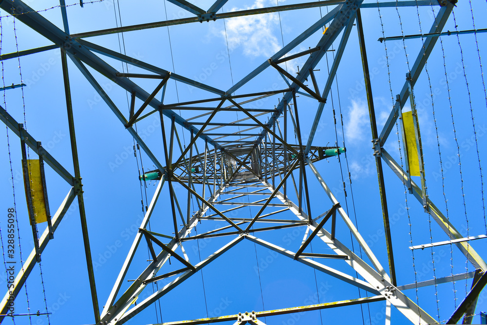 electricity pylon against blue sky