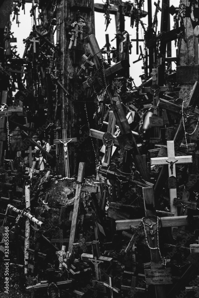 Numerous crucifixes on the hill of crosses in Lithuania. Concept of death, despair, and destruction. Black and white