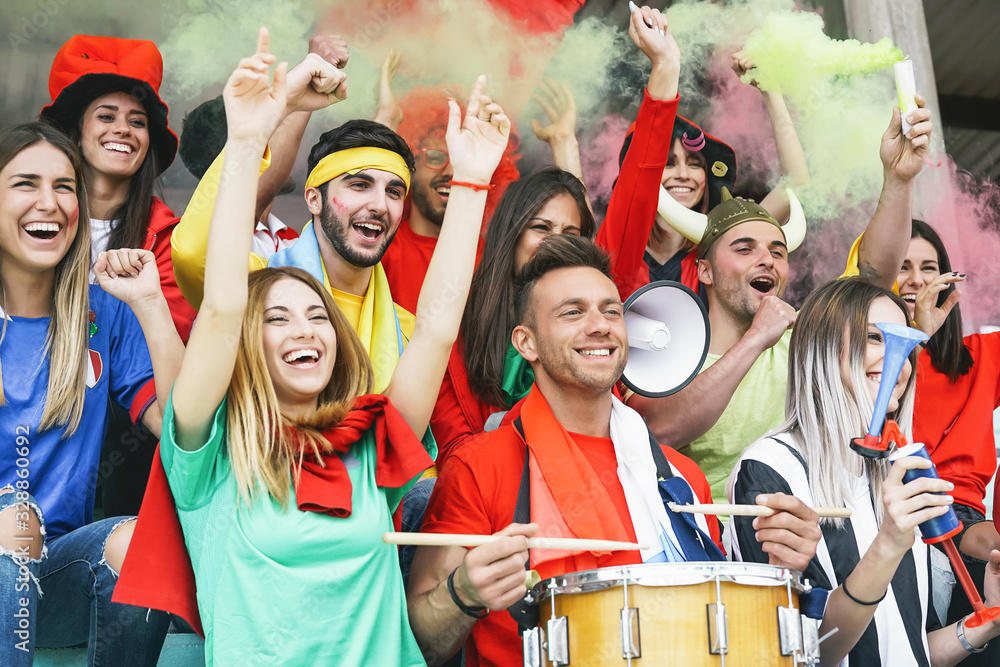 Fototapeta premium Friends football supporter fans watching soccer match event at stadium - Young people having fun supporting club on sport world championship - Youth entertainment lifestyle concept