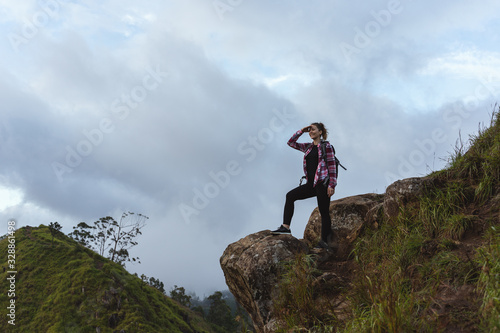 Young Woman observing the panorama from the top of the mountain in Ella in Sri Lanka.
