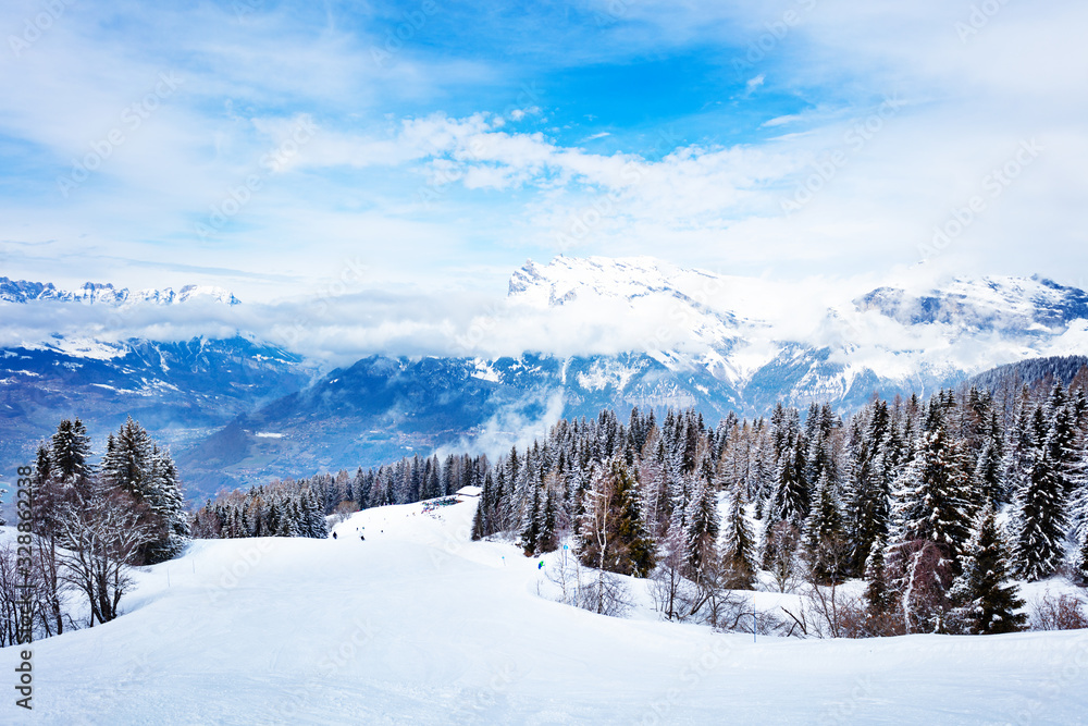 Alpine ski slope and mountain range peaks of Mont-Blanc, Chamonix region, Auvergne-Rhone-Alpes in south-eastern France