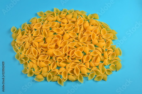 Raw conchiglie rigate pasta on blue background photo