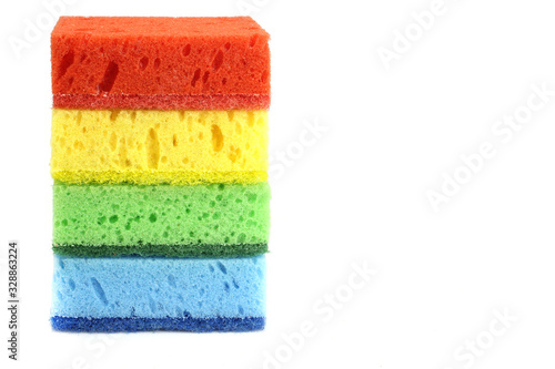 A stack of colored kitchen sponges for dishes , household cleaning is isolated on white background.