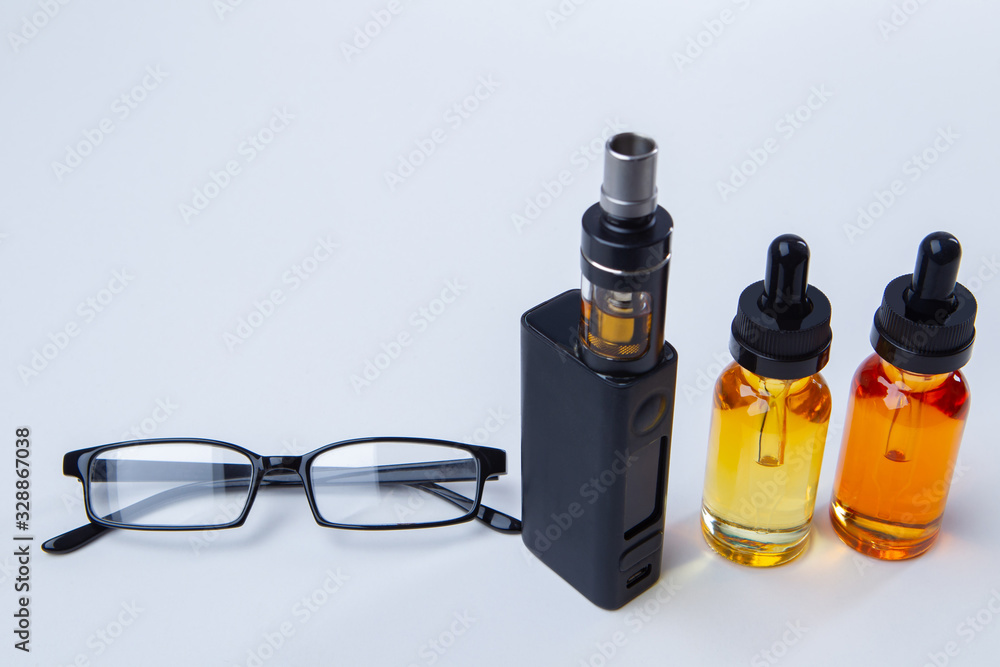skat usikre Låse Vaping accessories on a white table. Smoking concept. Fashion for electronic  cigarettes. E-cigarette and liquids on the table. VAPE shop. Stock Photo |  Adobe Stock