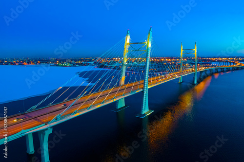 Saint Petersburg. Russia. Bridges Of St. Petersburg. Vansu bridge. Obukhov bridge across the Neva. Neva river under the ice. Evening Petersburg. Road traffic on the bridge.