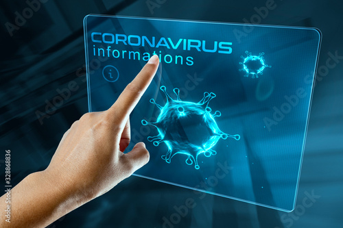 a woman's finger click information on the corona virus on a digital screen