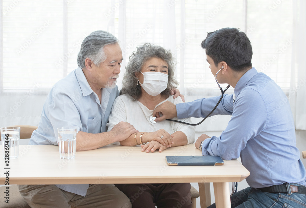 Young caucasian doctor man talking result of examination on file folder to senior elderly old retirement asian woman with old man take care her beside.healthcare and medical concept. Young caucasian doctor man talking result of examination on file folder to senior elderly old retirement asian woman with old man take care her beside.healthcare and medical concept.