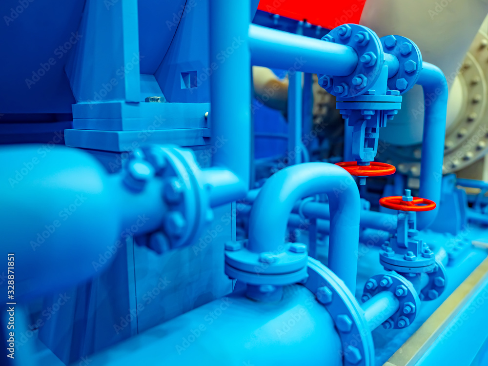 Blue pipe line. Red taps on blue pipes. Gas distribution system. Gas pipelines. Transportation of fuel through pipes. Liquefied natural gas. Red valves. Pipe connection. Chemical industry. Blue pipe line. Red taps on blue pipes. Gas distribution system. Gas pipelines. Transportation of fuel through pipes. Liquefied natural gas. Red valves. Pipe connection. Chemical industry.