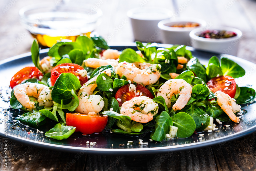 Prawn salad on wooden table Prawn salad on wooden table