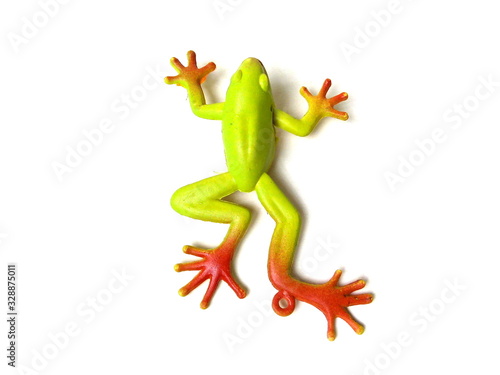 Close up of green frog toy isolated on white background. Artificial frog. Kids toy. Rubber toy.