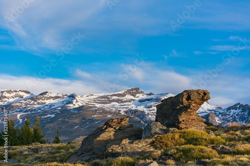 View of snowy mountains with the first lights of dawn