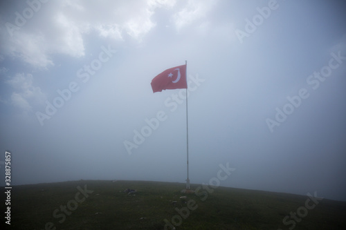 turkey flag against blue sky fogg