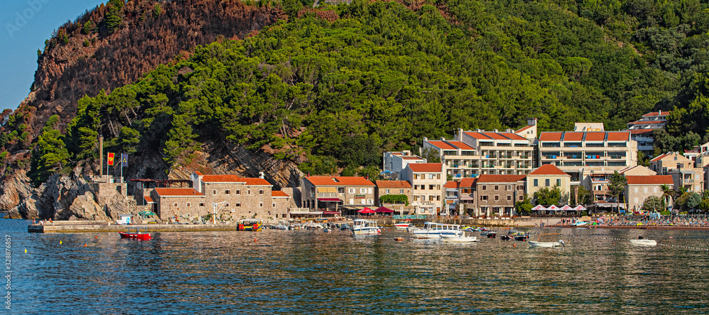 View on Petrovac and its beach in summer full of tourists