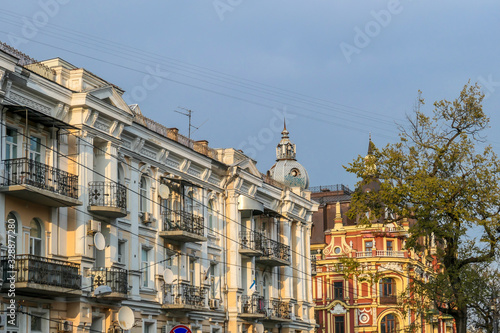 A row of old buildings captured during the golden hour in Kiev, Ukraine. Buildings have different colors, with detailed and ornate facade. Big city life.