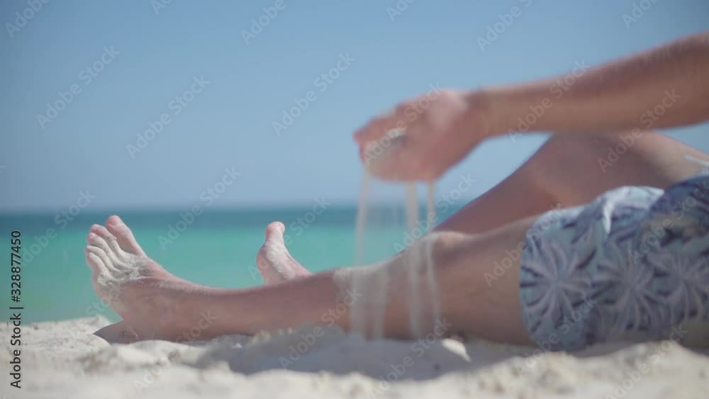Guy Relaxing On Tropical Beach.Happy Calm Healthy Young Man Resting On Ocean.Hand Playing With Sand On Bahamas Vacation Holiday.Man Pouring Sand Through Fingers.Guy Sitting On Beach Caribbean Coast Guy Relaxing On Tropical Beach.Happy Calm Healthy Young Man Resting On Ocean.Hand Playing With Sand On Bahamas Vacation Holiday.Man Pouring Sand Through Fingers.Guy Sitting On Beach Caribbean Coast