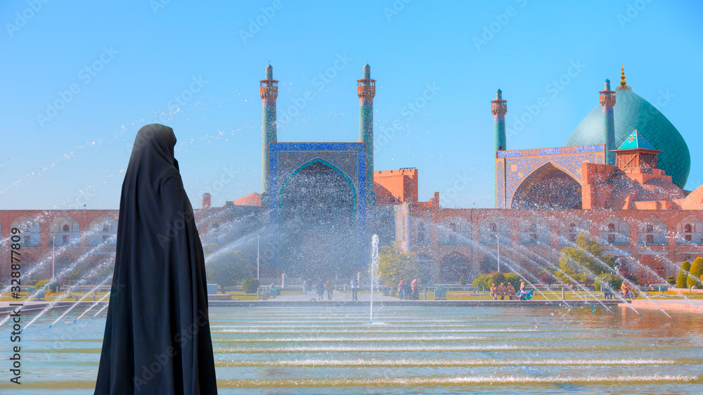 Iranian woman wearing abaya standing by the poolside - Shah (Imam) Mosque (Jameh Abbasi Mosque), Imam mosque in Naghsh-i Jahan Square - Isfahan, Iran,