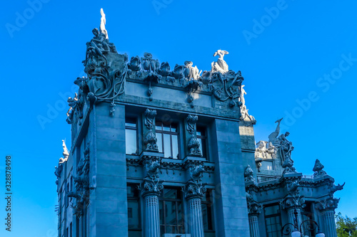 House with Chimaeras/Horodecki House build in Art Nouveau style in Kiev, Ukraine. House is decorated with various animals, like rhinos, sums, eagles, elephants, frogs or snakes. Clear blue sky photo