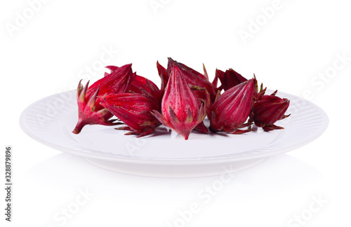 Roselle fruits on plate isolated on white background.
